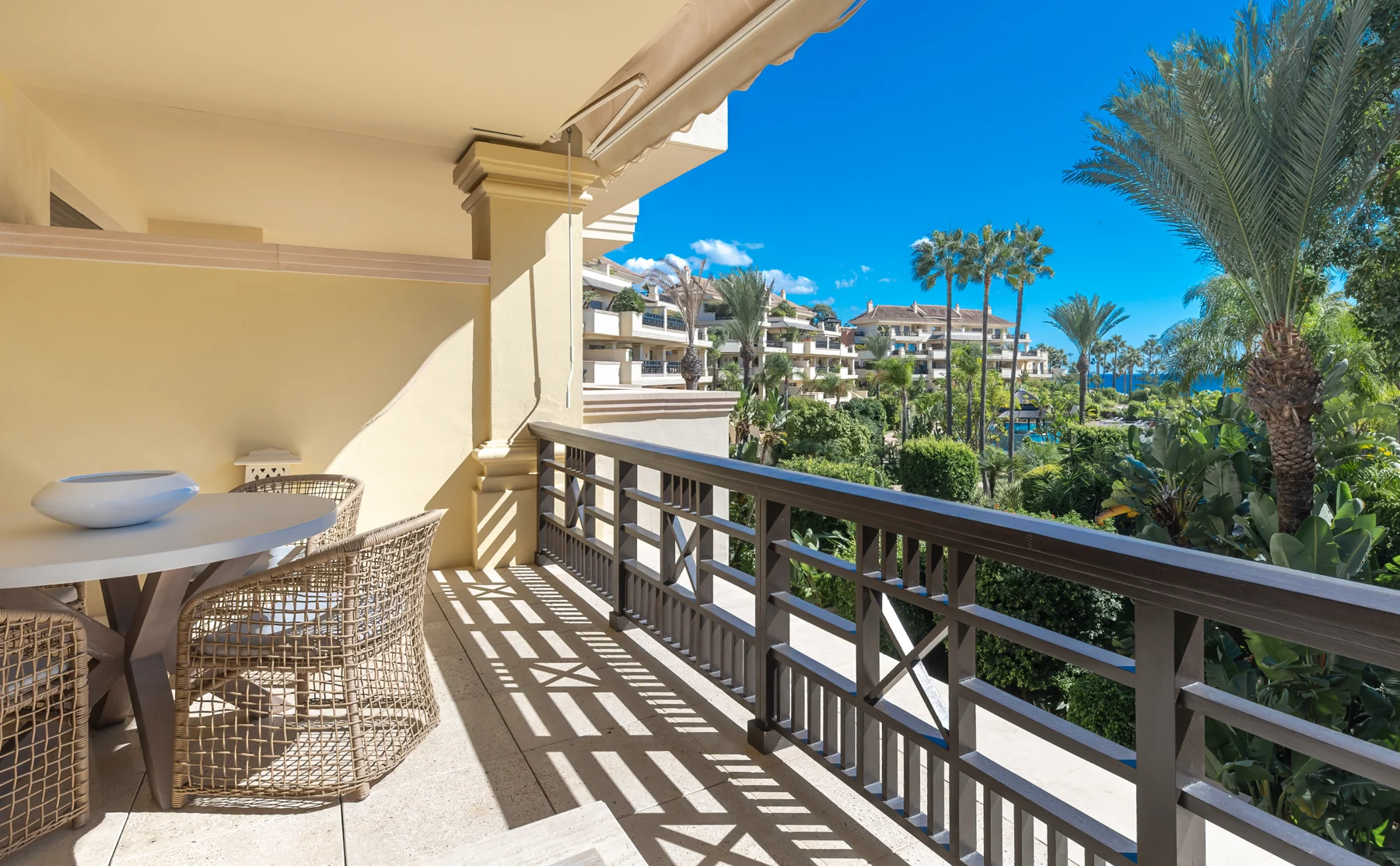 Outward view from the terrace over tropical gardens with a partial sea view