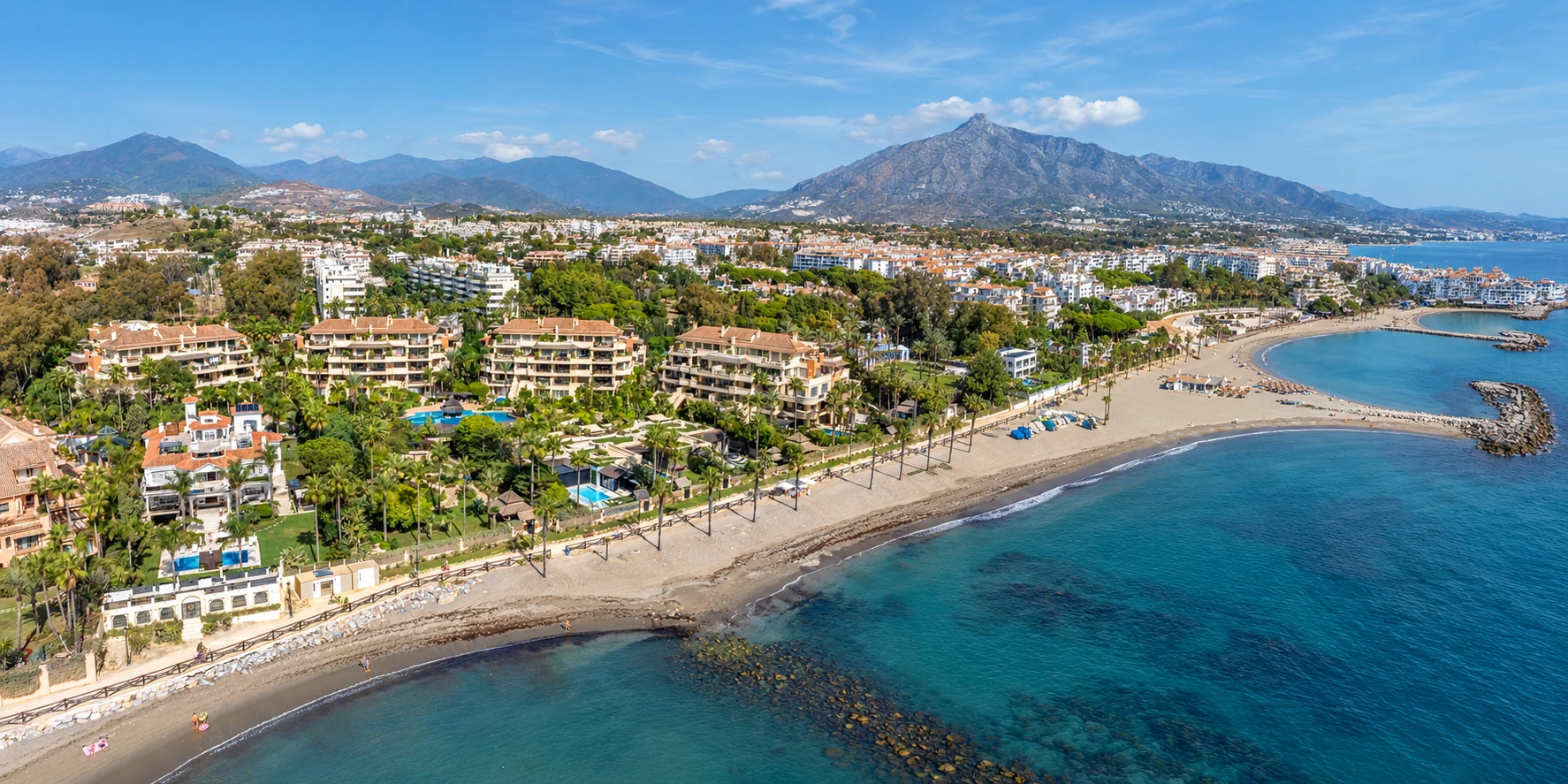 Panoramic composite showing Laguna de Banús, the coastline and mountain backdrop